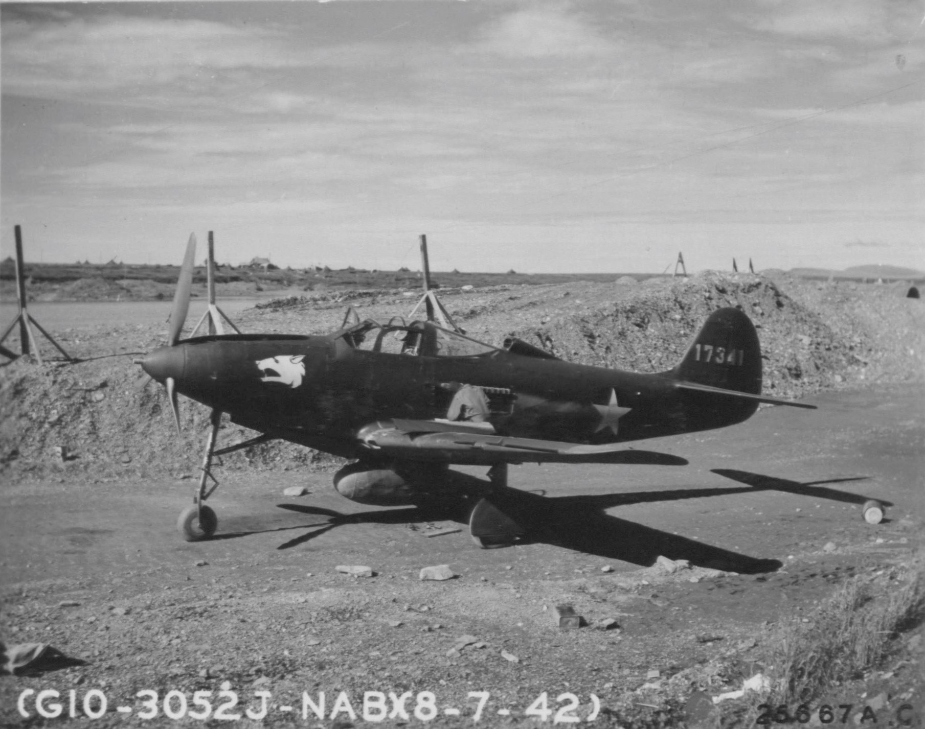 Bell P-39 in parking area, with alert crew on duty