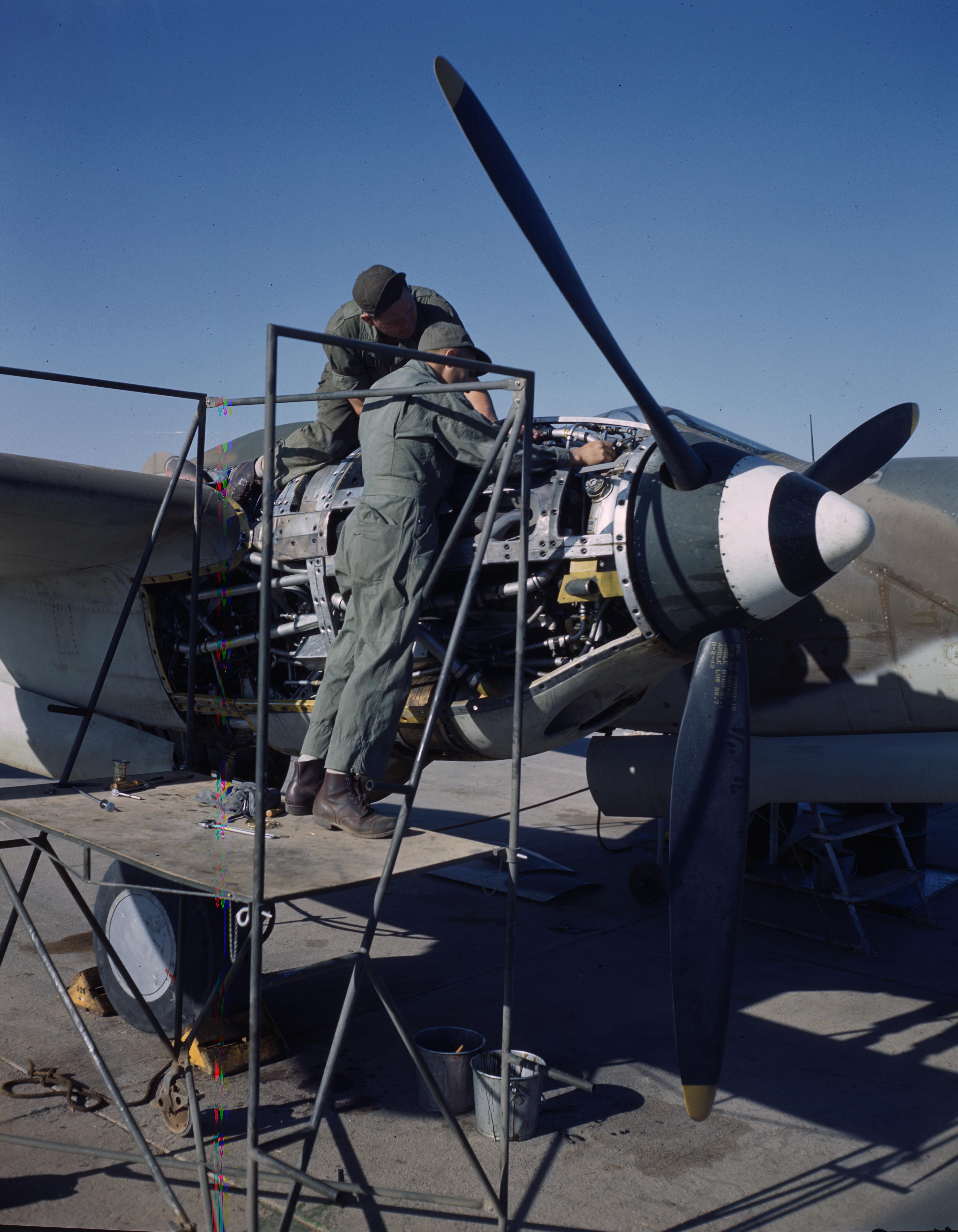 Mechanics overhauling a Lockheed P-38