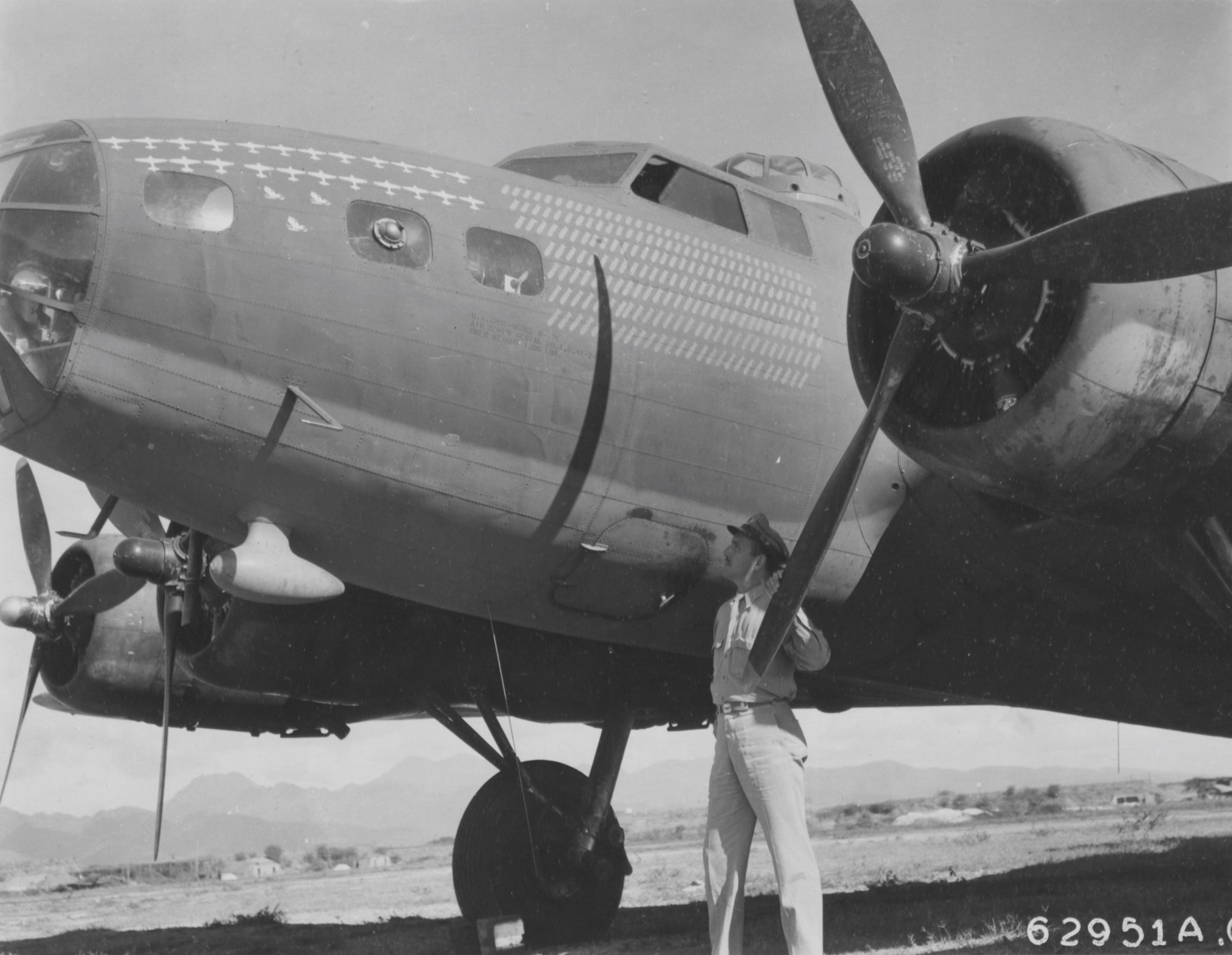 Officer stands beside B-17, Hickam